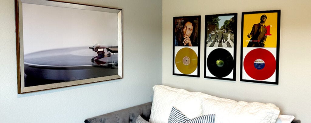 Image of various record albums, framed on the wall. 