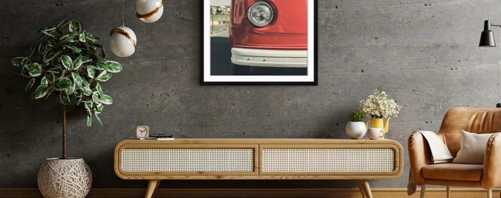 Image of car framed hanging above mid-century modern credenza. 